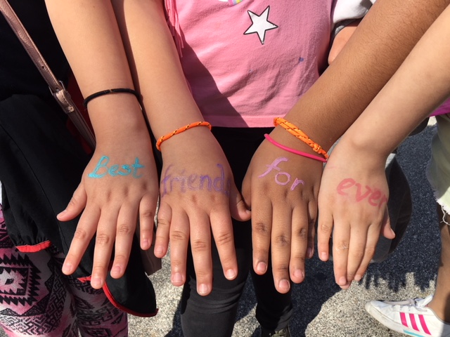 Writing on children's hands reads "Best Friends Forever"
